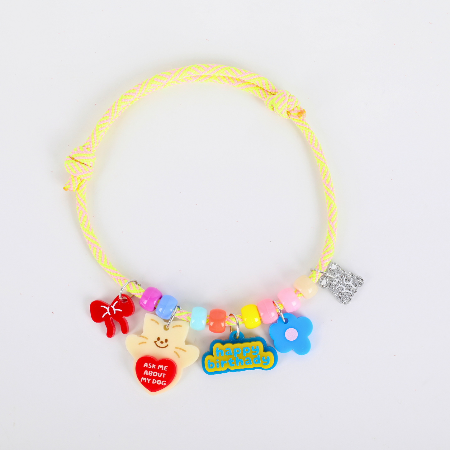 Colorful pets necklace with various charms on a white background