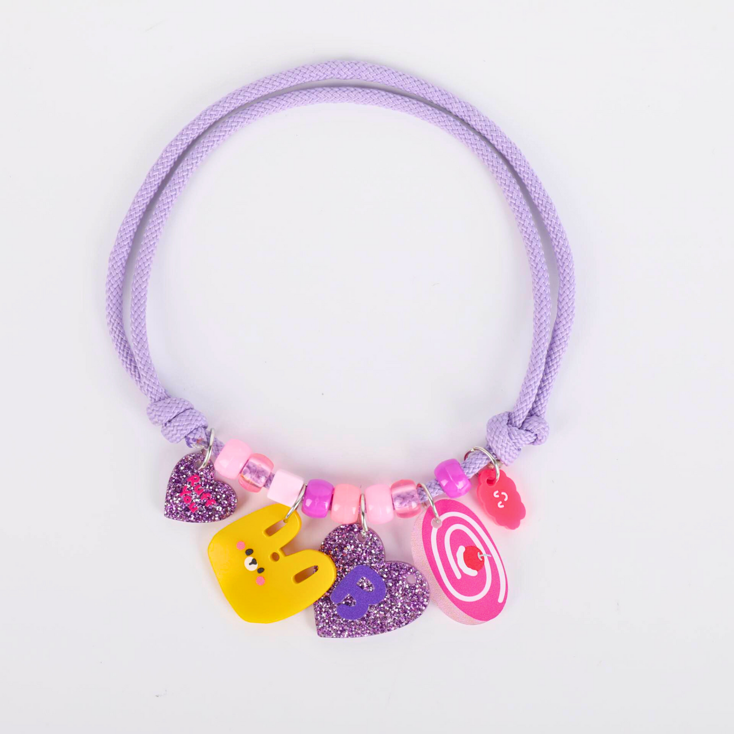 Purple pet collar with colorful charms on a white background
