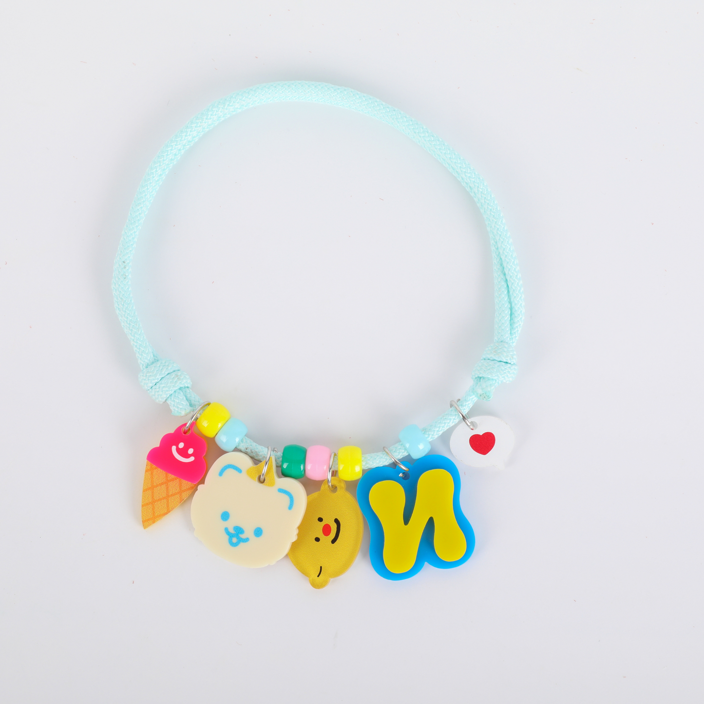 Colorful pet collar with various charms on a light gray background