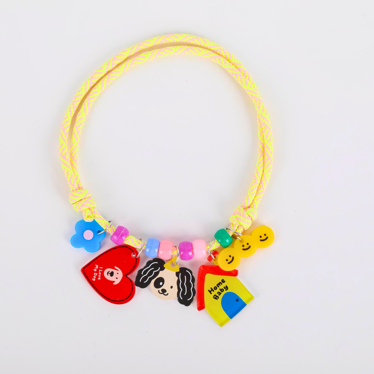 Colorful pet's necklace with various charms on a white background
