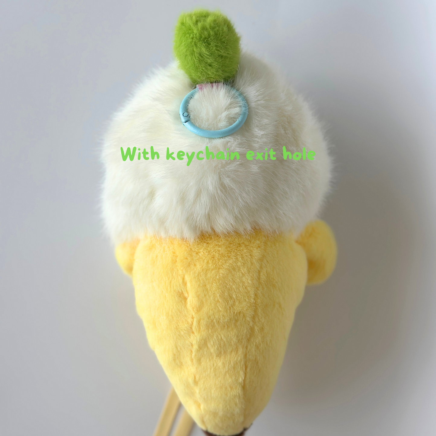 Complete back view of banana costume for Labub showing white fluffy top with green pompom, yellow body, and ribbon ties