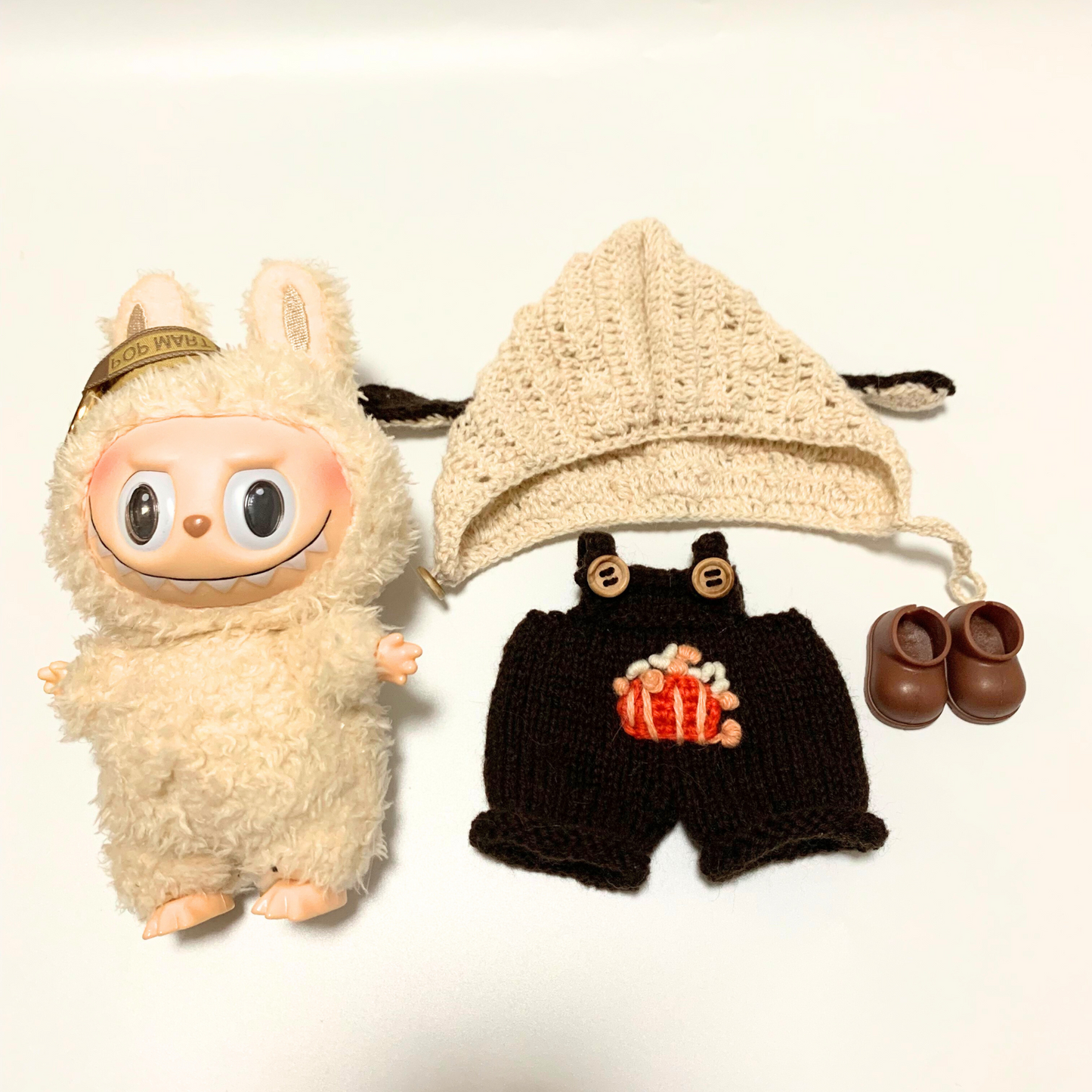 Labubu plushie with complete knitted bunny ear hoodie and brown overalls outfit set featuring embroidered popcorn design, wooden buttons and brown shoes
