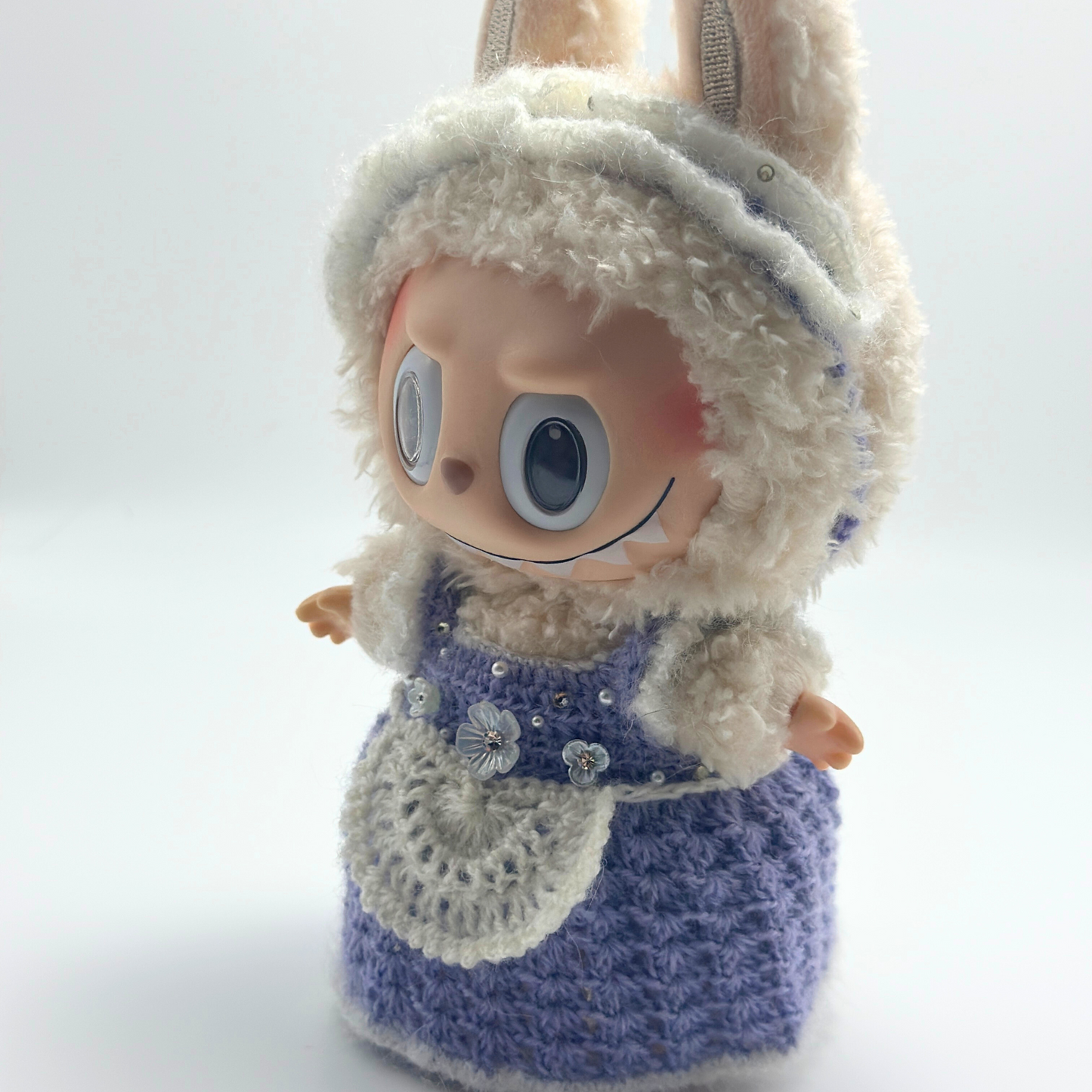 labubu with a blue dress and white hood on a white background