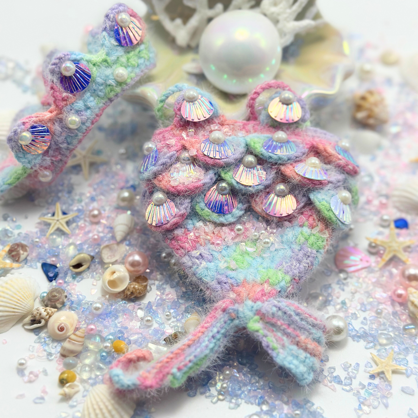 Detailed view of Labubu mermaid costume showing iridescent holographic shell sequins, pearl accents, and rainbow fuzzy mermaid tail with ocean coral backdrop