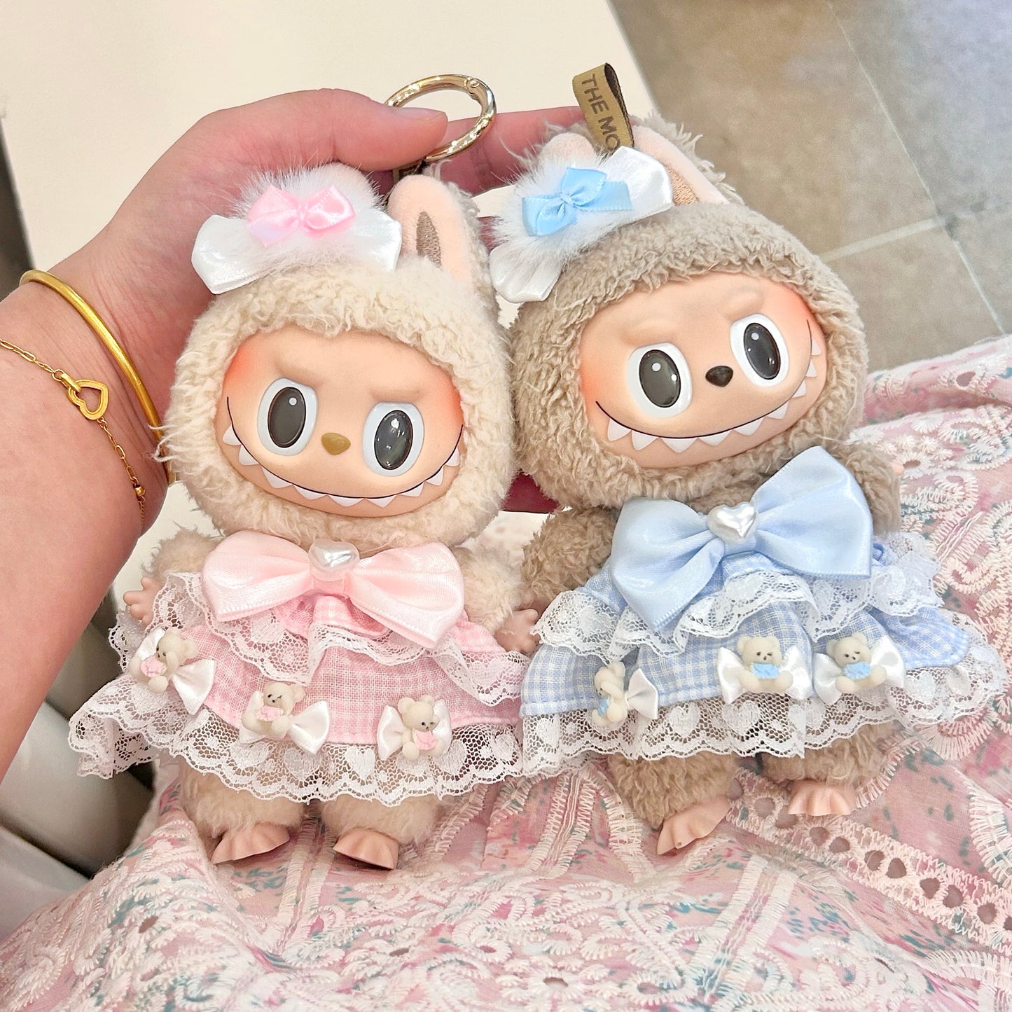 Labubu doll keychain couple set - matching sweet Lolita outfits in pink and blue with white lace trim, satin bows, bear decorations and gold keyring attachments