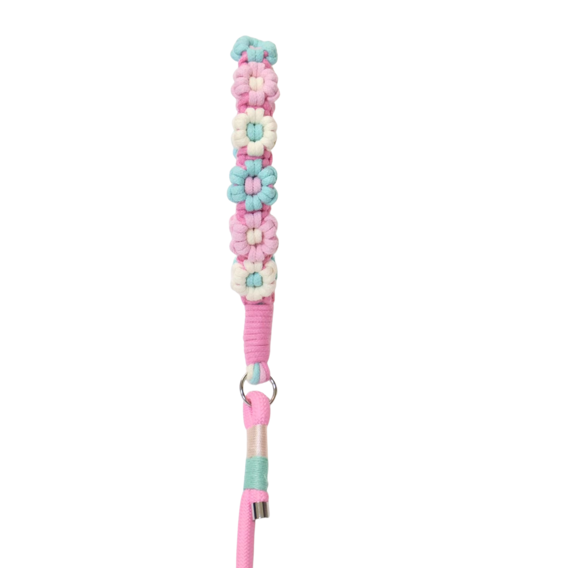 A decorative dog leash handle covered with layered artificial daisy flowers in pastel colors including mint green, pink, white, and cream, with pink rope wrapping and a metal ring at the bottom