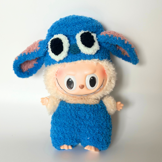 Labubu doll dressed in a handmade blue Stitch inspired outfit with fluffy fabric, big ears, and cute collectible costume style