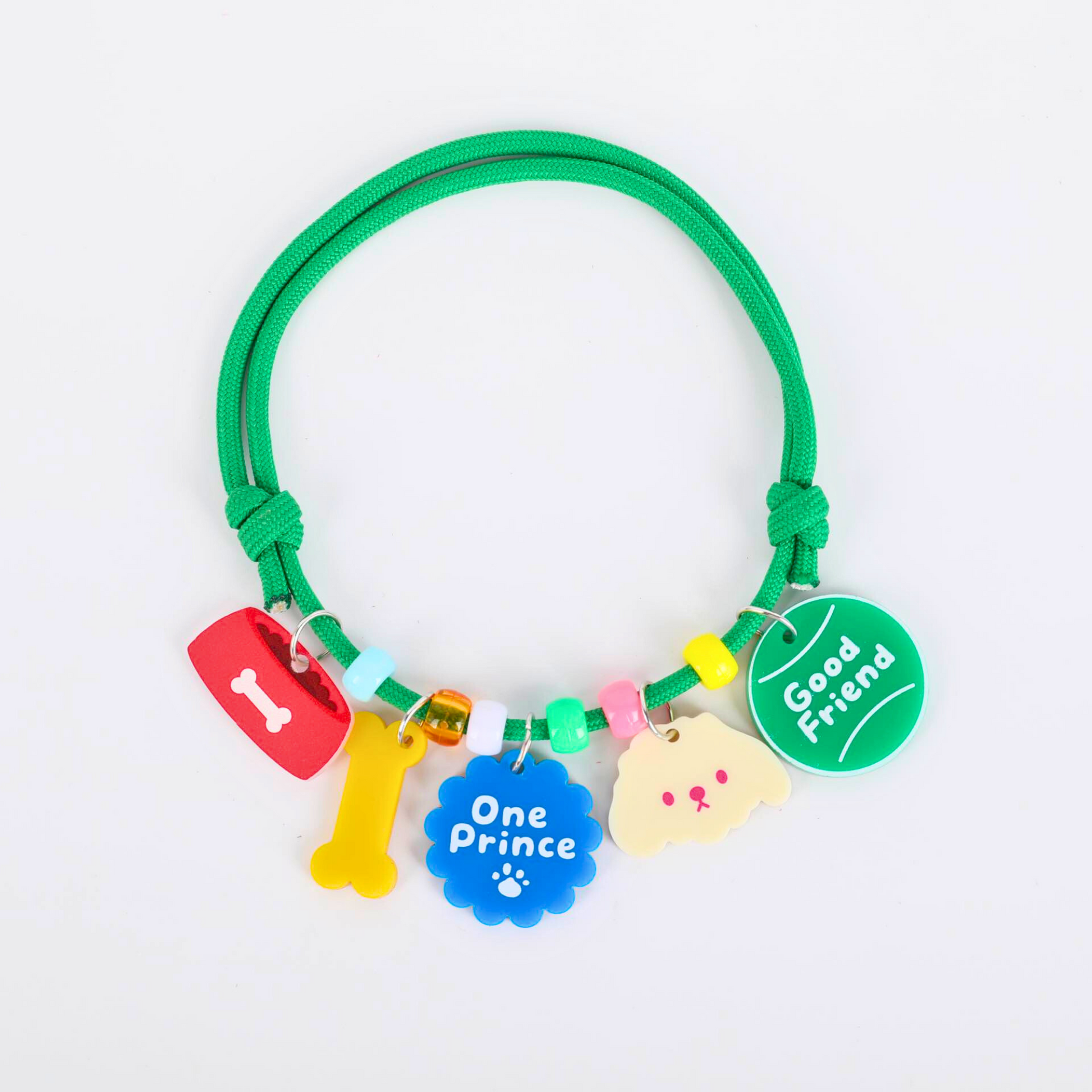 Green pet necklace with colorful charms on a white background
