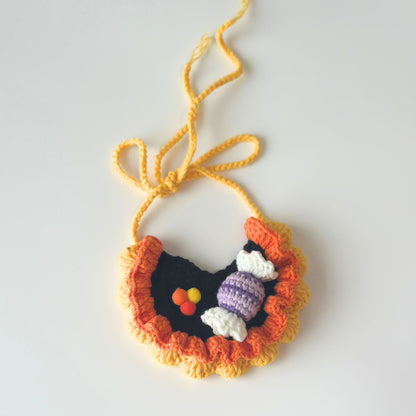 Crocheted necklace with colorful pendant on a white background