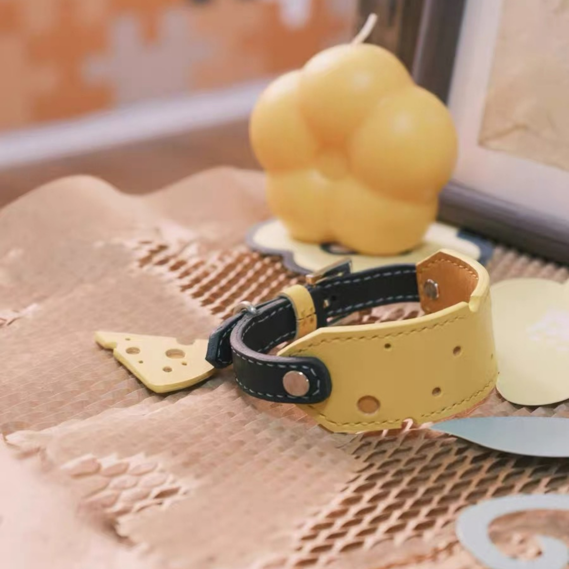 Premium leather pet collar with cheese pattern holes - yellow and black dog collar with chef hat candle lifestyle photography