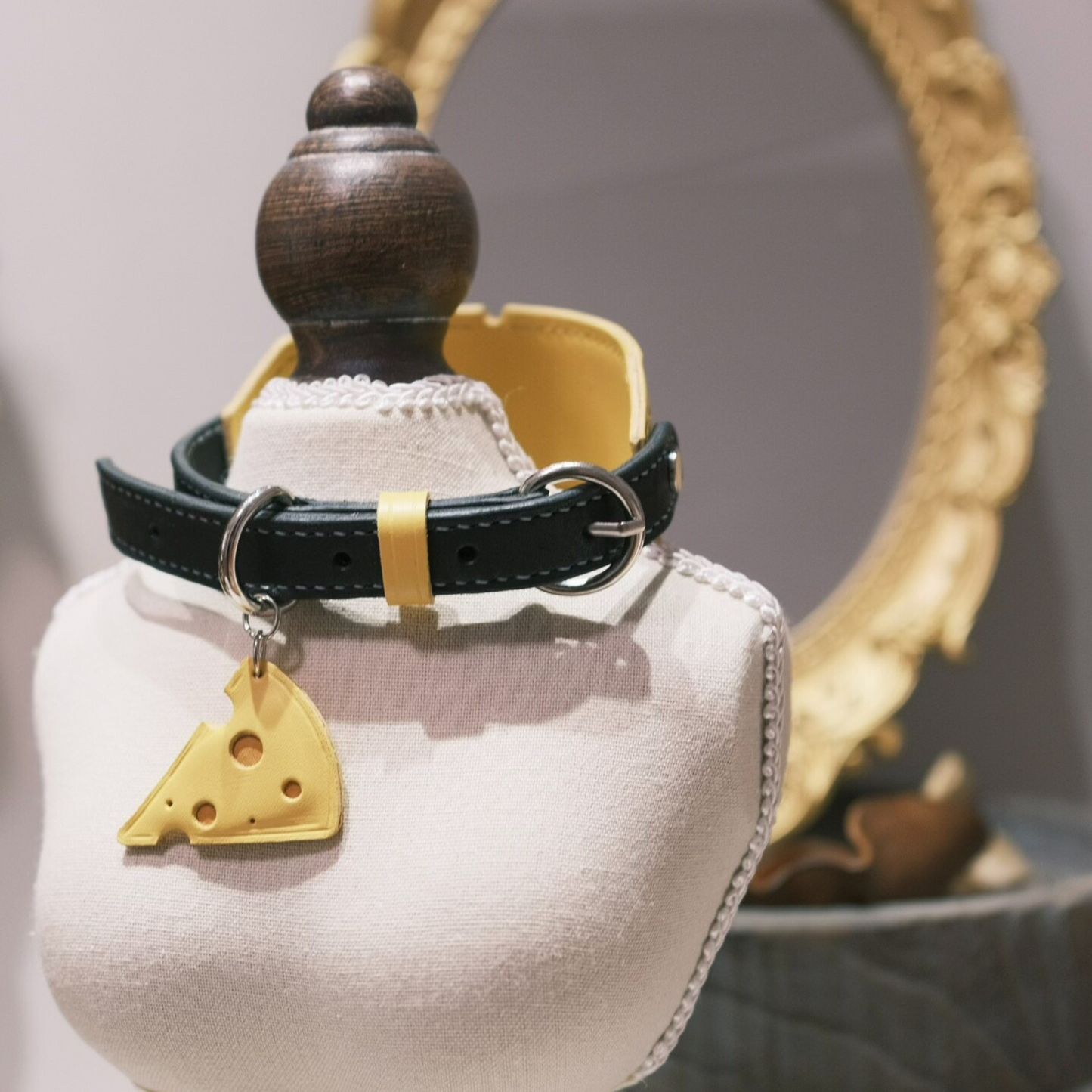 Yellow leather pet collar with cute cheese slice charm pendant and decorative cloud-shaped accent, featuring black stitching and adjustable buckle