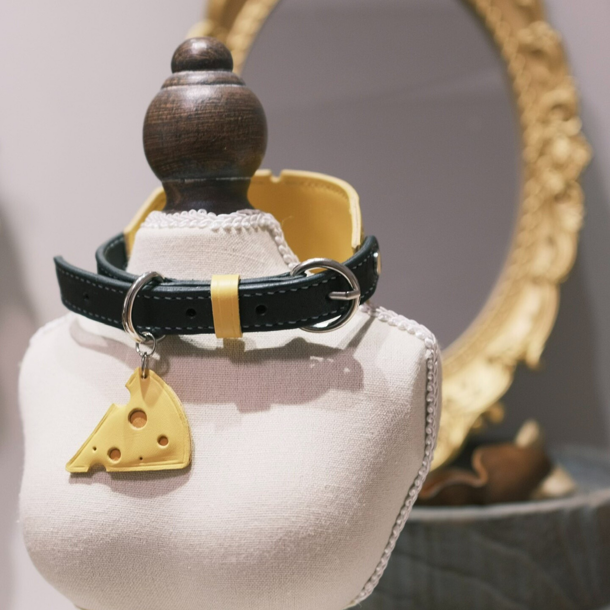 Yellow leather pet collar with cute cheese slice charm pendant and decorative cloud-shaped accent, featuring black stitching and adjustable buckle