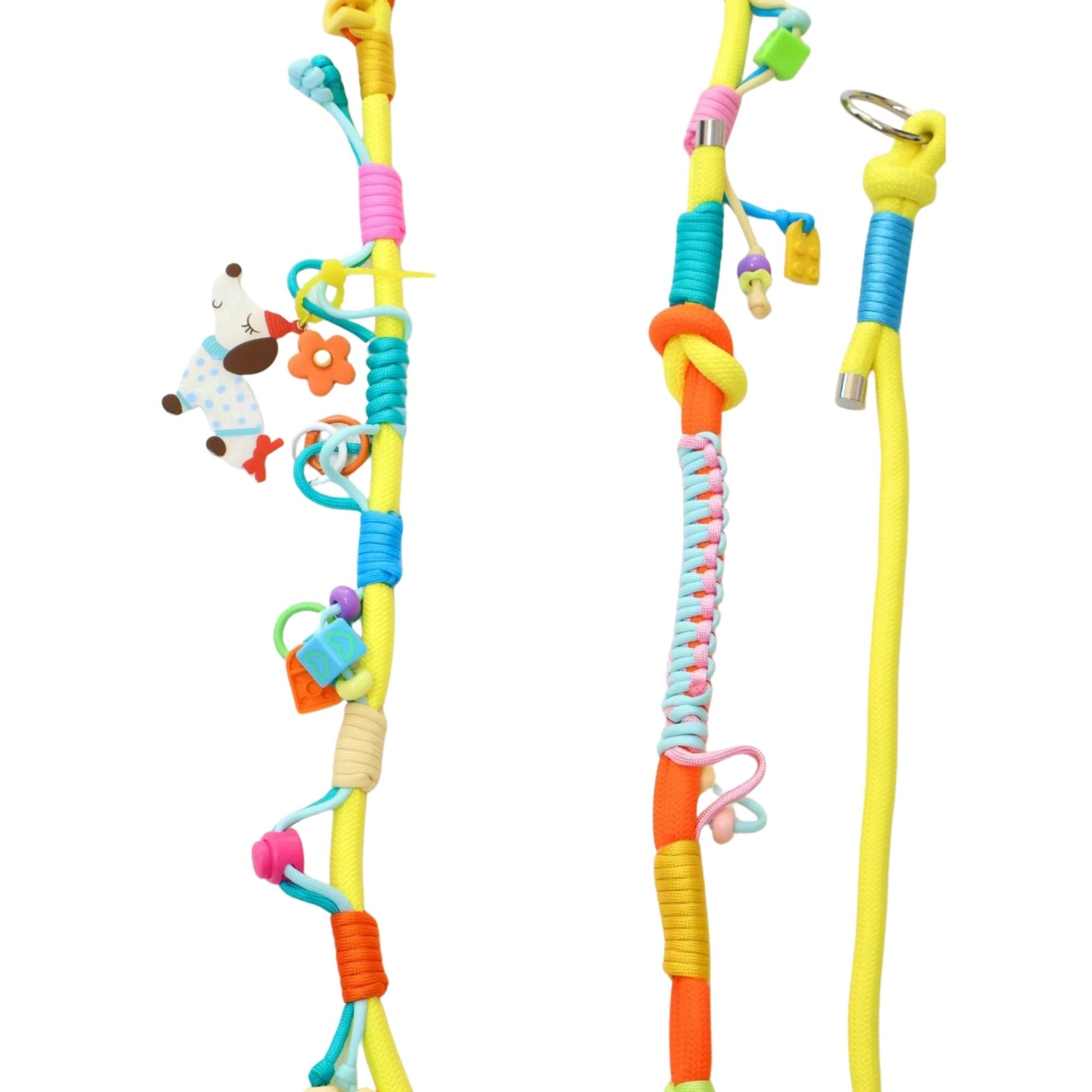 Close-up detail of handmade pet leashes showing colorful rope wrapping in yellow, blue, pink and orange. Left leash features a cute cow-print toy charm and various small decorative elements. Middle leash has braided sections and small hanging charms. Right leash shows yellow rope with blue accent wrapping and metal ring details