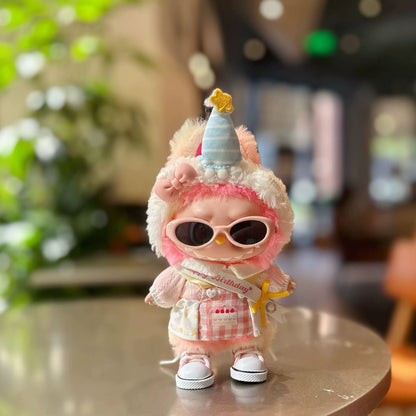 Single Labubu doll wearing birthday celebration costume with pink sunglasses in natural lighting setting