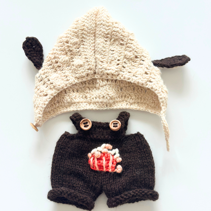 Flat lay of Labubu bunny ear hoodie and brown overalls clothing set showing cream knitted hoodie with ears and embroidered popcorn overalls with wooden buttons