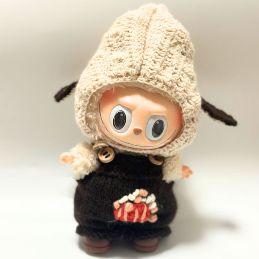Labubu wearing handmade knitted bunny ear hoodie and brown overalls outfit with embroidered design and wooden button details