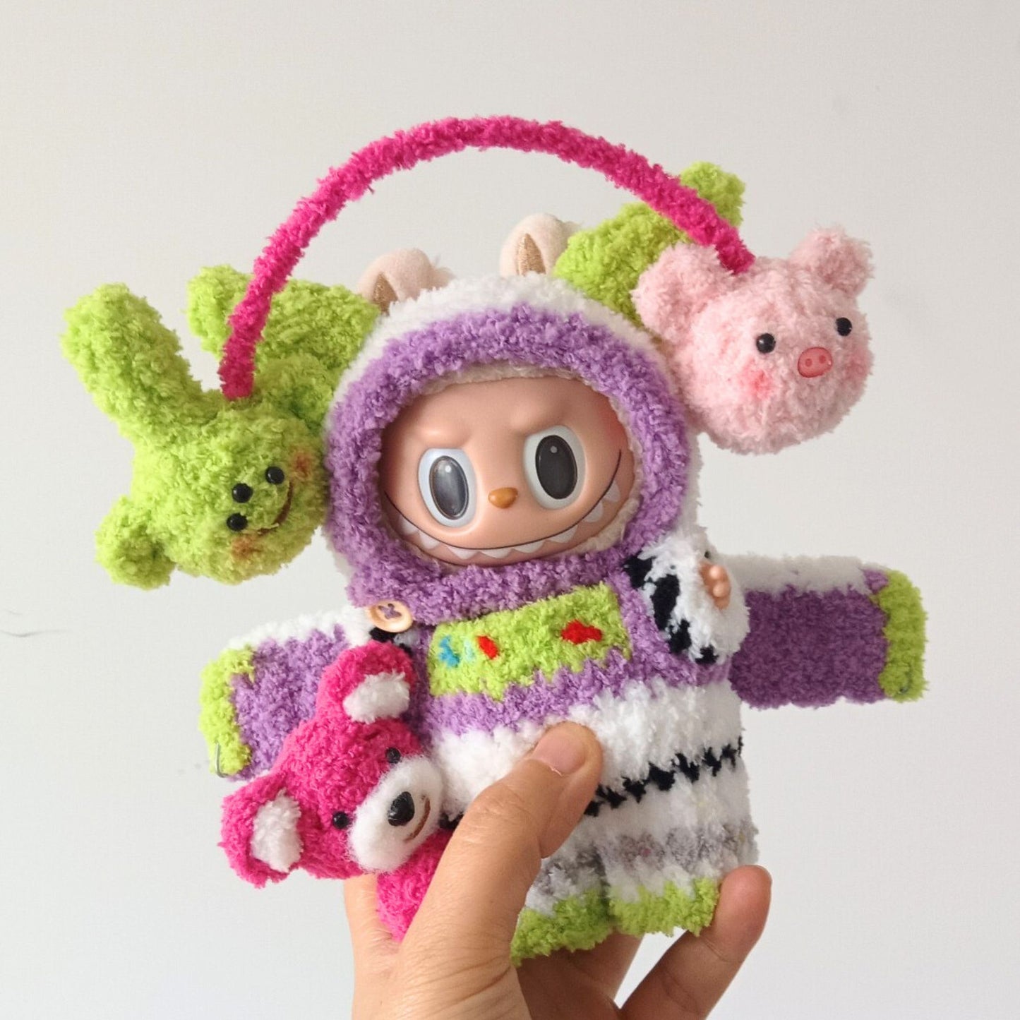 Labubu doll wearing Buzz Lightyear inspired costume with purple fluffy hood, colorful space ranger outfit, and