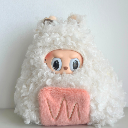Labubu doll wearing salmon onigiri (rice ball) costume with white fuzzy hoodie and pink knitted body representing salmon filling - cute Japanese food-themed doll outfit