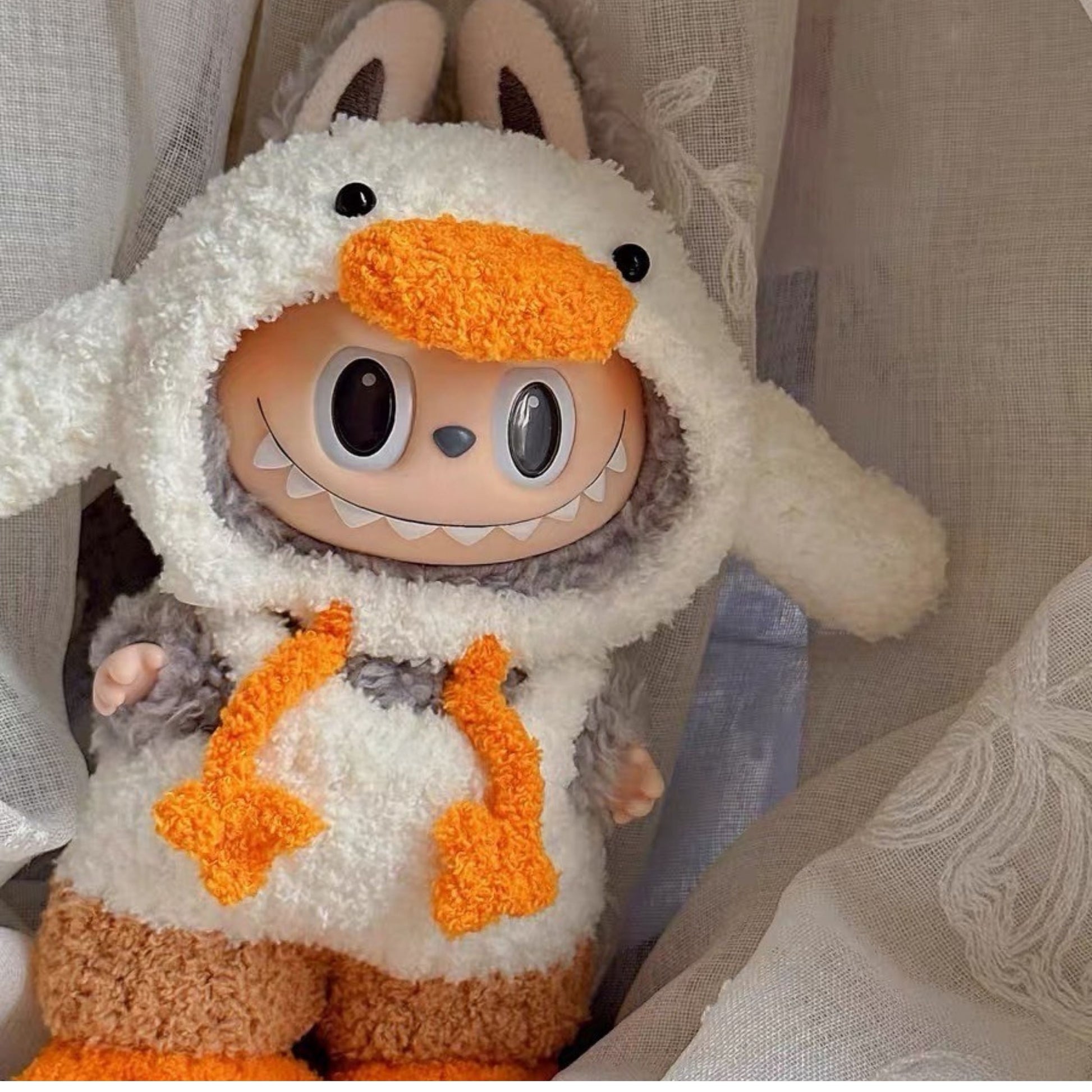Cute Labubu collectible wearing cozy duck-inspired outfit with hoodie and fluffy pants