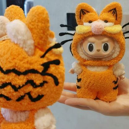 Labubu doll wearing a handmade Garfield-style orange plush outfit with cat ears and whiskers, cute fluffy costume inspired by Garfield.