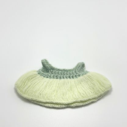 Knitted labubu dress with green top and light green bottom on a white background