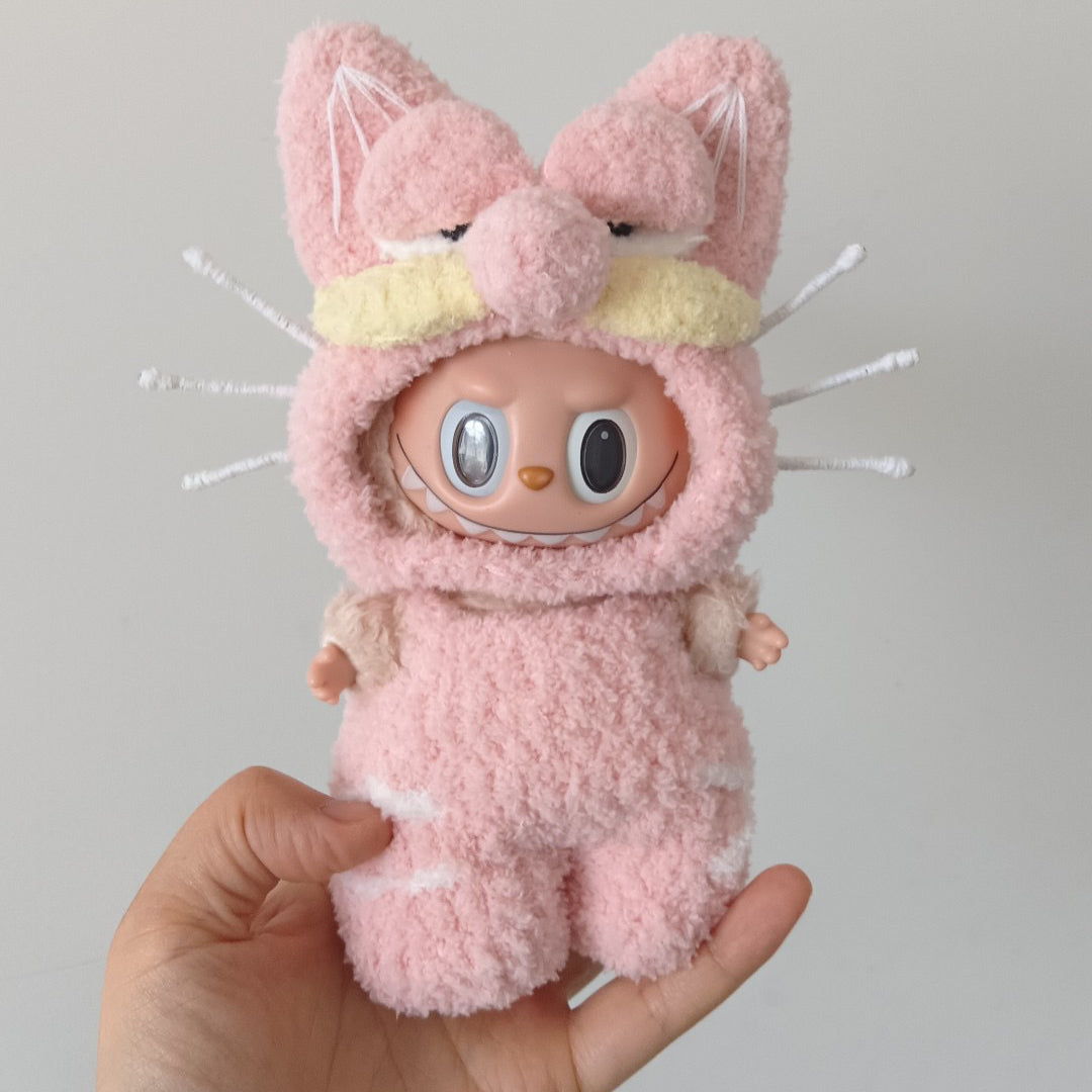 labubu  wearing pink garfield outfit with cat ears held by a hand against a gray background