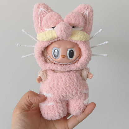 labubu  wearing pink garfield outfit with cat ears held by a hand against a gray background