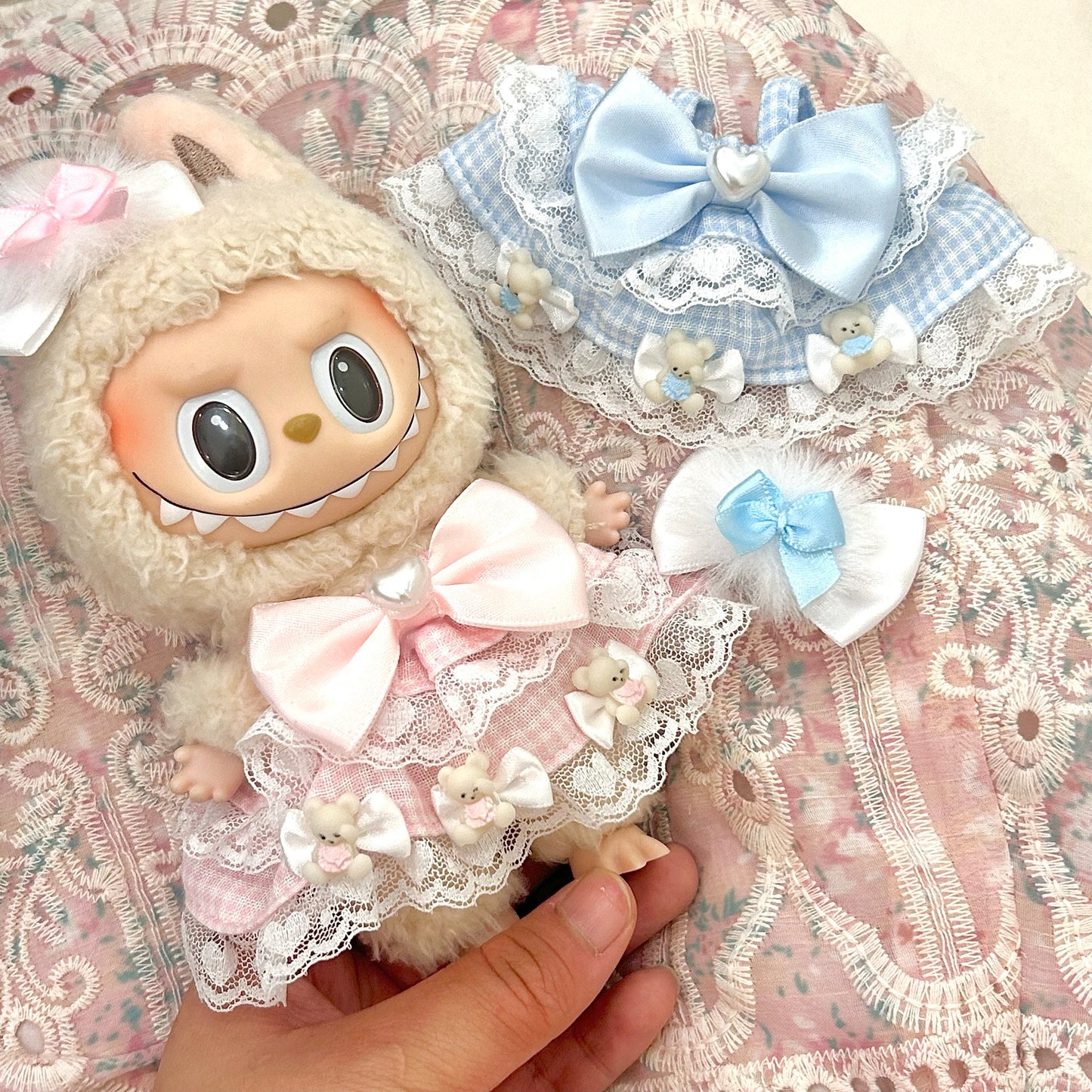 Labubu doll sweet Lolita dress in pastel blue and pink with white lace trim, decorative satin bows and adorable bear details