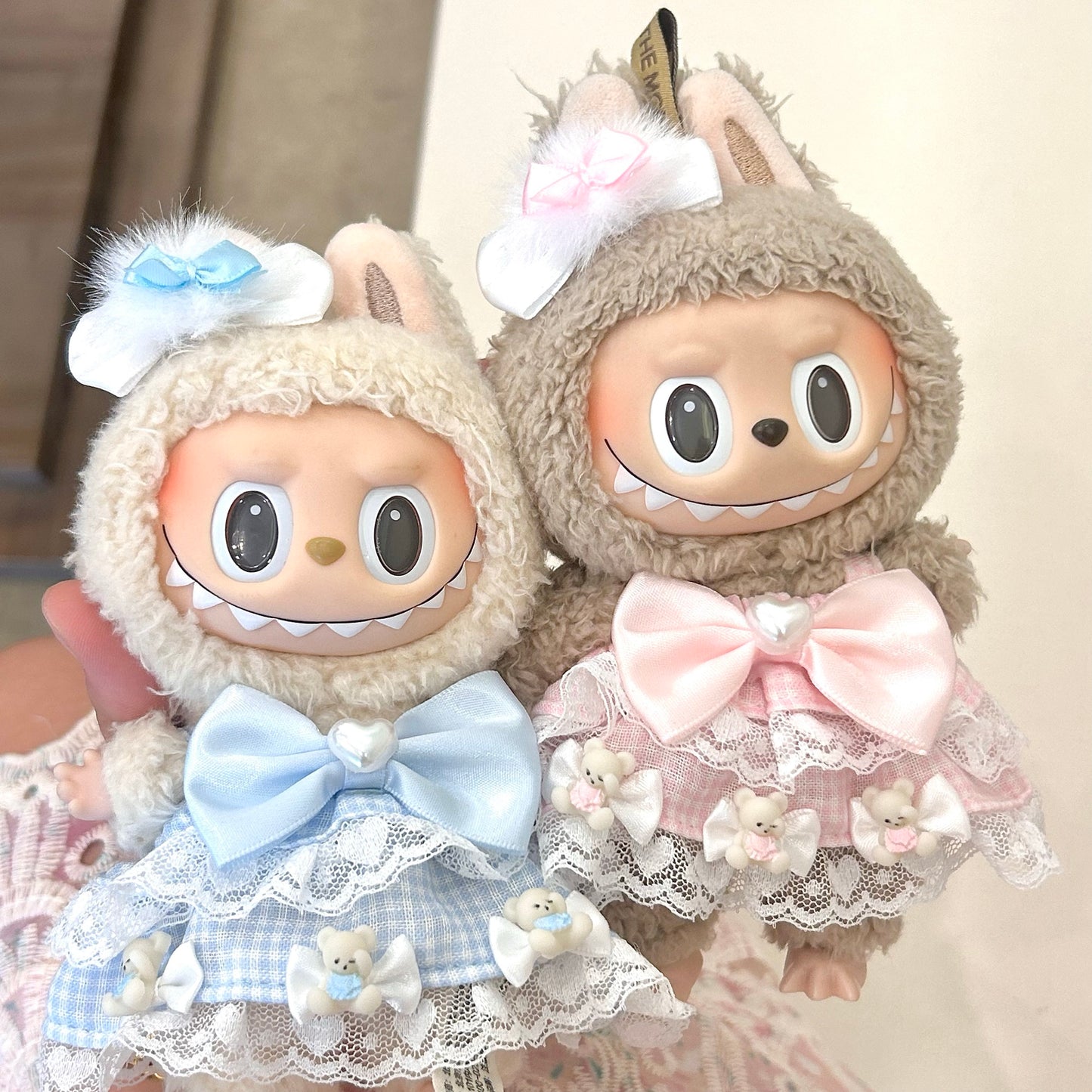 Labubu doll couple outfit set - matching sweet Lolita dresses in pastel blue and pink with white lace trim, satin bows and adorable bear details