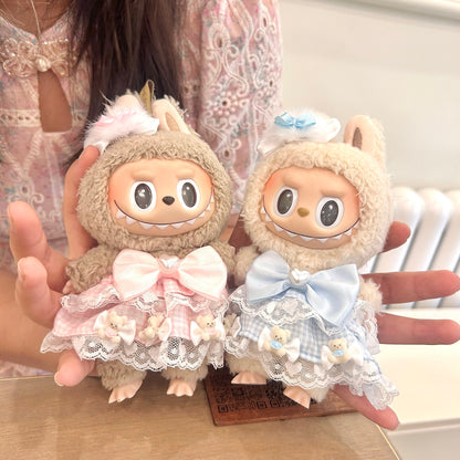 Labubu doll couple dress set - matching sweet Lolita outfits in pink and blue with white lace trim, satin bows and adorable bear details, shown handheld for size reference