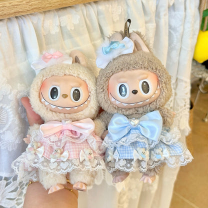 Labubu doll couple dress set - matching sweet Lolita outfits in pink and blue with white lace trim, satin bows and bear details, beautifully displayed against romantic white lace backdrop