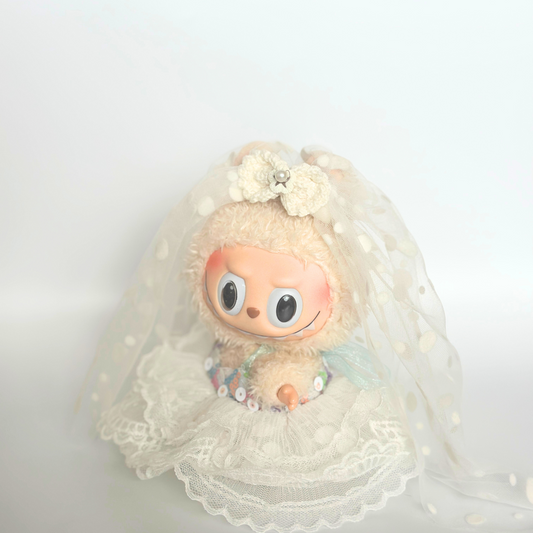 Labubu doll wearing white lace wedding dress with flower hair accessories and layered tulle skirt, cute doll costume outfit