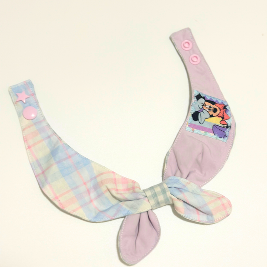 Pastel-colored pet bib with cartoon character on a white background