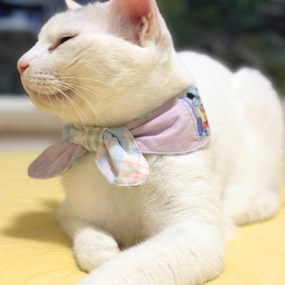 Cat wearing a colorful bandana on a blurred background