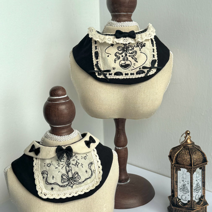 Black and white embroidered bandanas on mannequin heads with a decorative lantern in the background.
