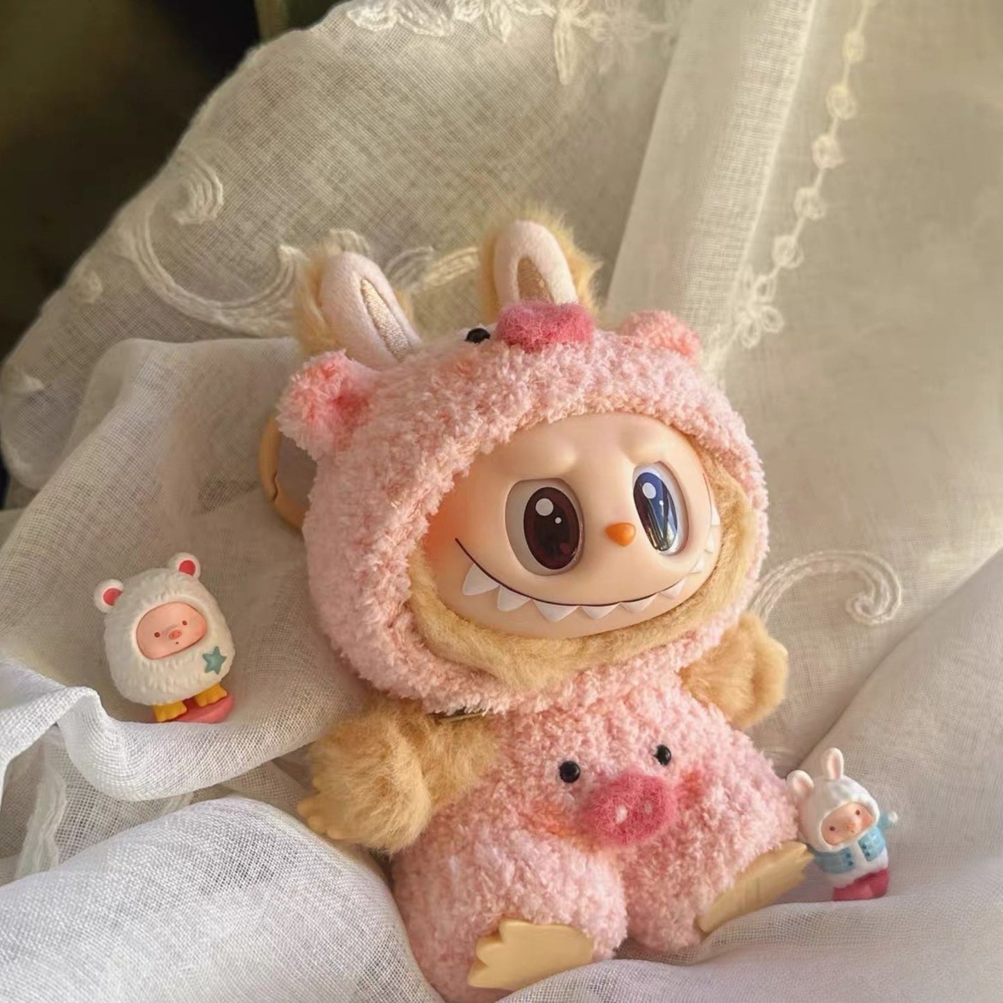 Labubu with pink pig design on a light fabric background