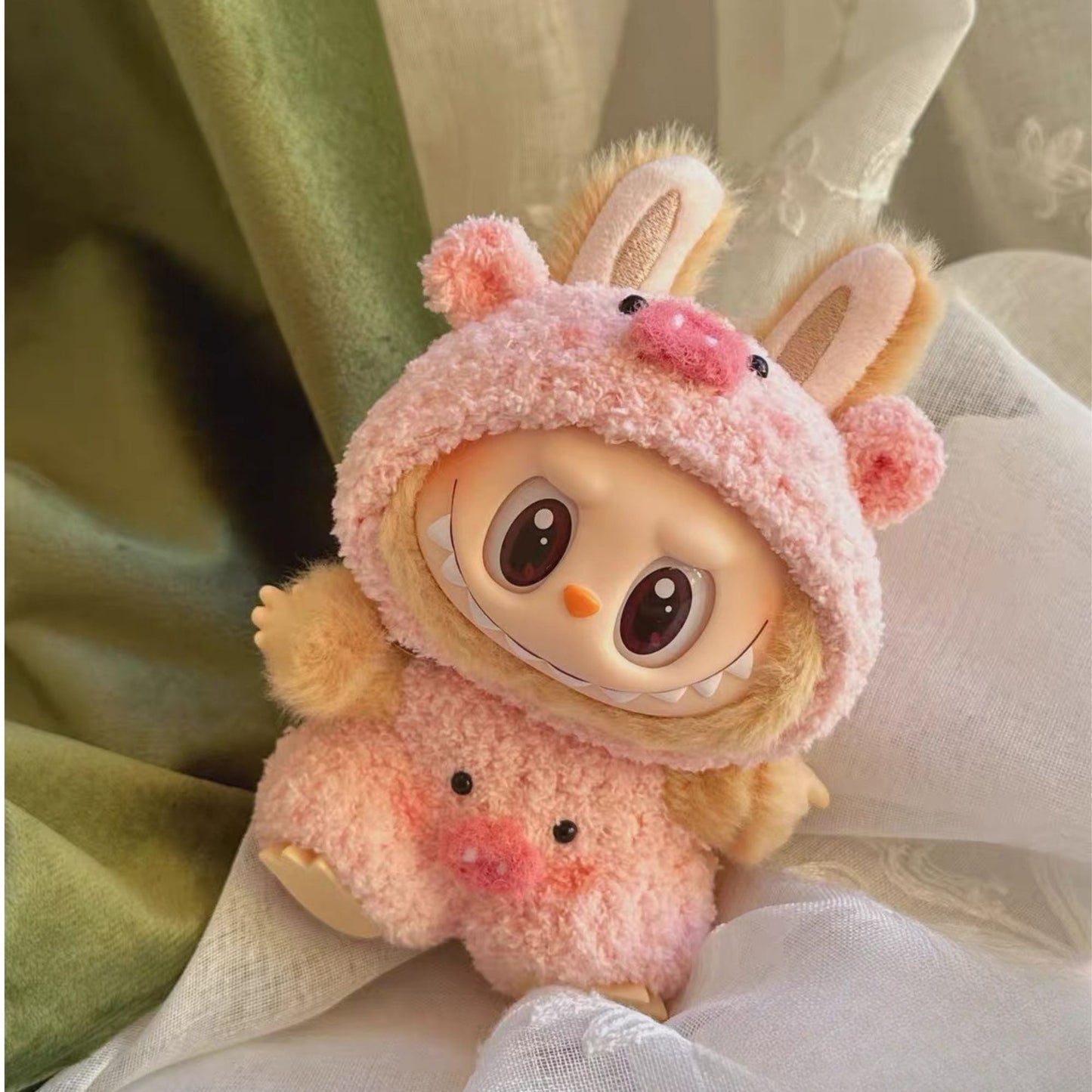 Labubu with a pink pig outfit on a soft background