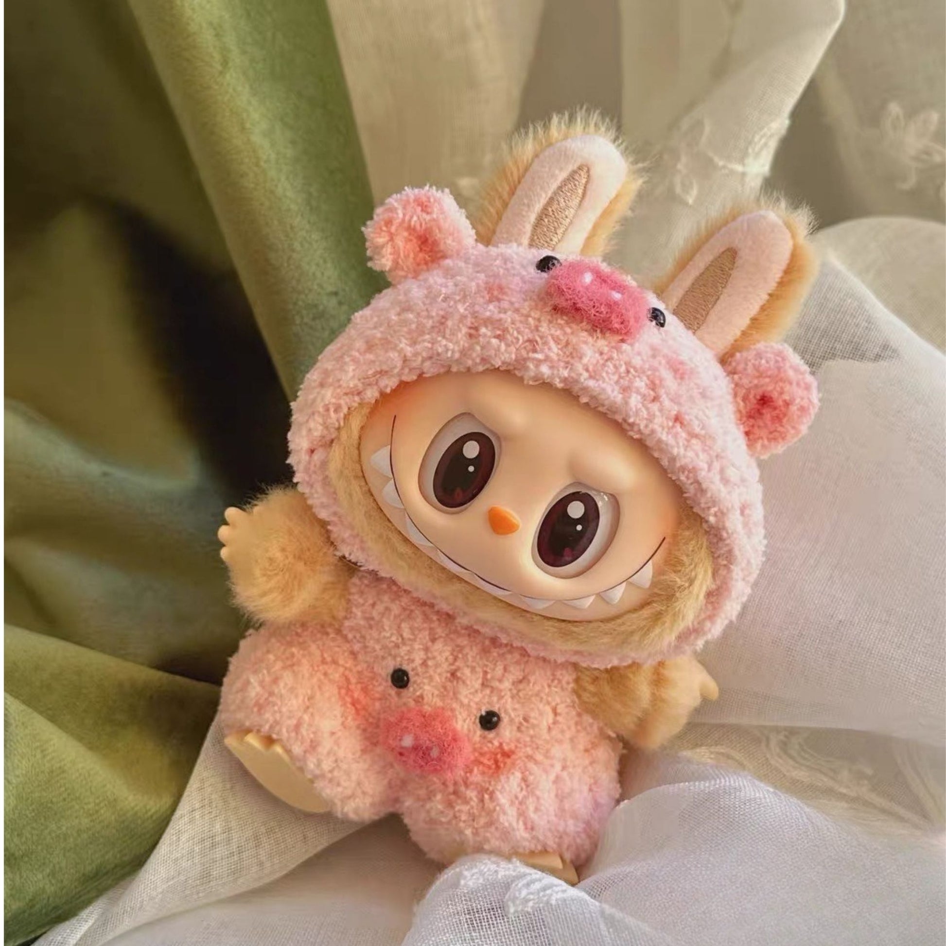 Labubu with a pink pig outfit on a soft background