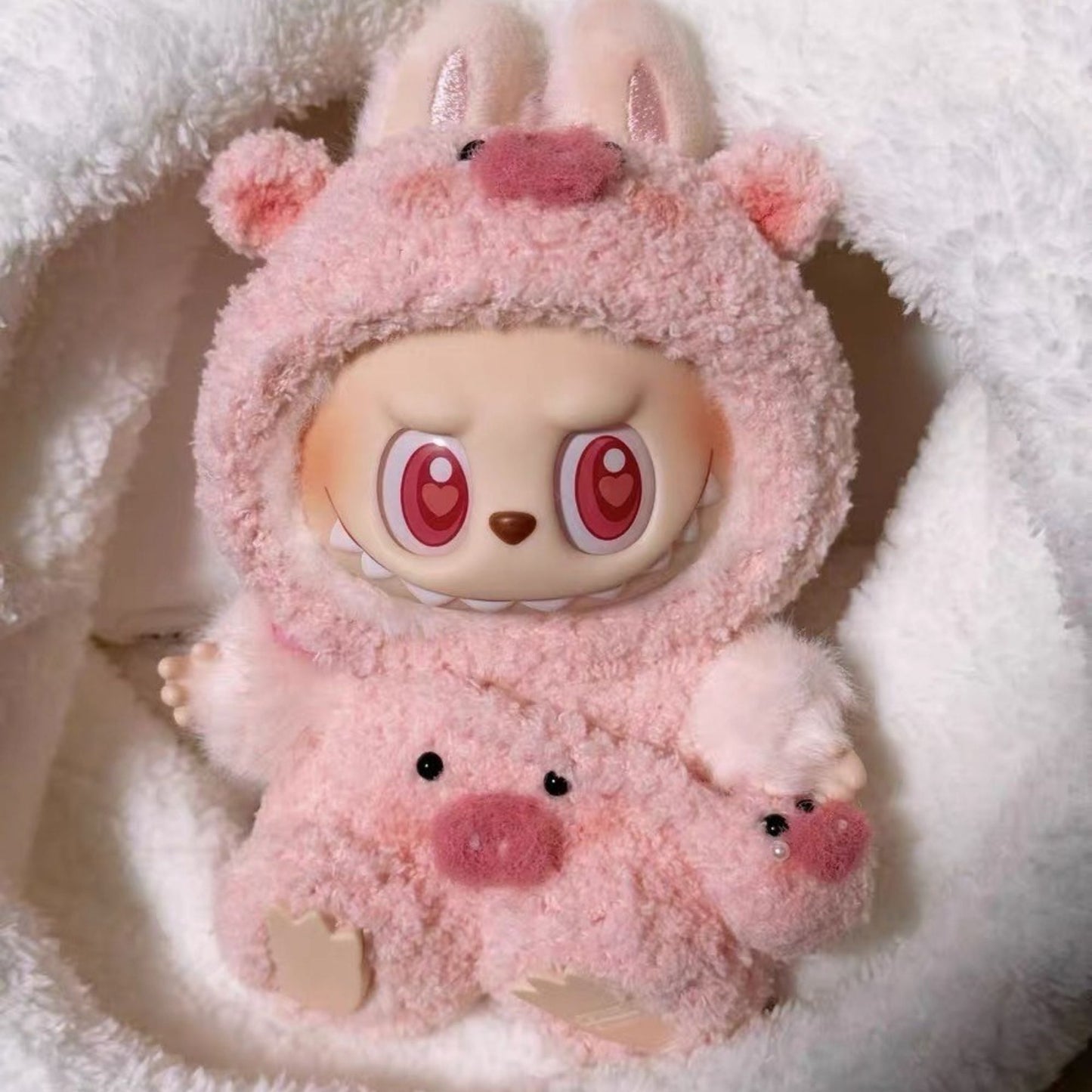 Labubu with a pink pig outfits and a pig bg on a white background